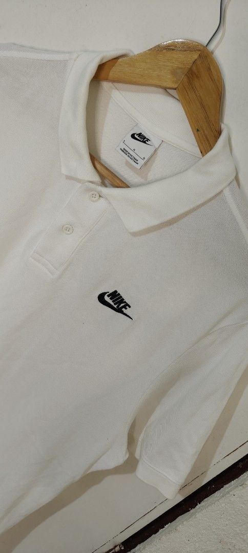 Nike White Polo Shirt Size L (Category: Tshirts & Polo Shirts ) located in Bulacan. Submitted by adrian2325 (Listing ID 1470111325, Image 2). Description: - Brand: Nike - Style: Classic polo shirt - Color: White - Size: L - Origin: Made in Vietnam - Material: Textured pique fabric - Details: Black embroidered Nike logo on left chest, standard two-button placket and collar - Condition: Clean, excellent, ready to wear - Best for: Casual outings or 