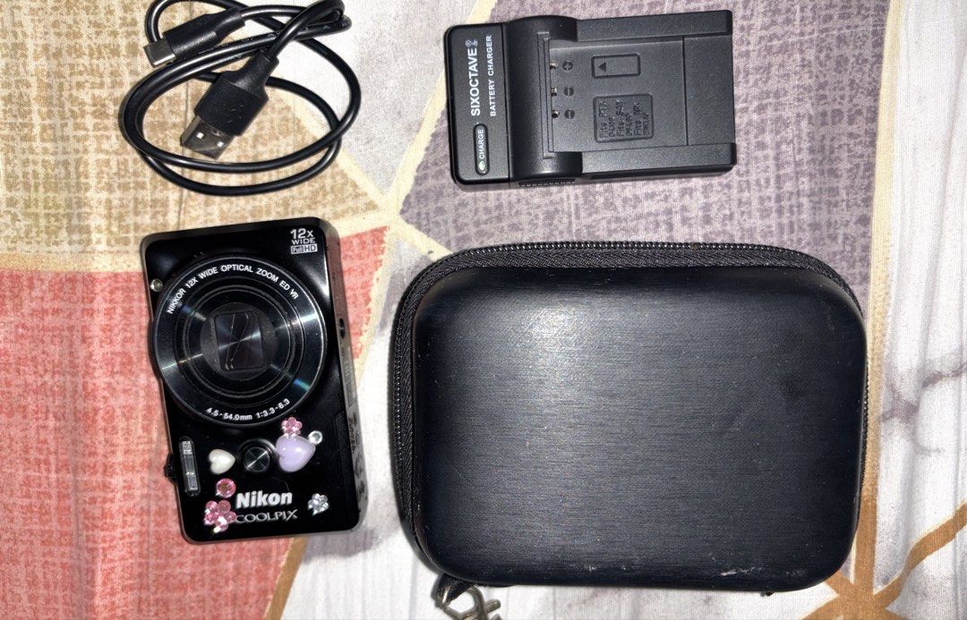 Nikon Coolpix Digital Camera Bundle with Charger and Case (Category: Cameras) located in Davao. Submitted by jay_rave26 (Listing ID 1470033853, Image 3). Description: - Model: Nikon Coolpix s6900 black (rare) compact digital camera (Black with cute stickers) - sample shots: last 2 slides - japanese language only but over all good - Lens: 12x optical zoom Nikkor lens - Condition: Fully working with clear test shot screen - Included Accessories: Si
