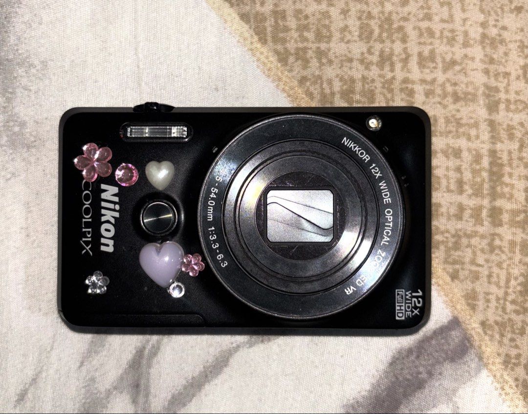 Nikon Coolpix Digital Camera Bundle with Charger and Case (Category: Cameras) located in Davao. Submitted by jay_rave26 (Listing ID 1470033853, Image 2). Description: - Model: Nikon Coolpix s6900 black (rare) compact digital camera (Black with cute stickers) - sample shots: last 2 slides - japanese language only but over all good - Lens: 12x optical zoom Nikkor lens - Condition: Fully working with clear test shot screen - Included Accessories: Si