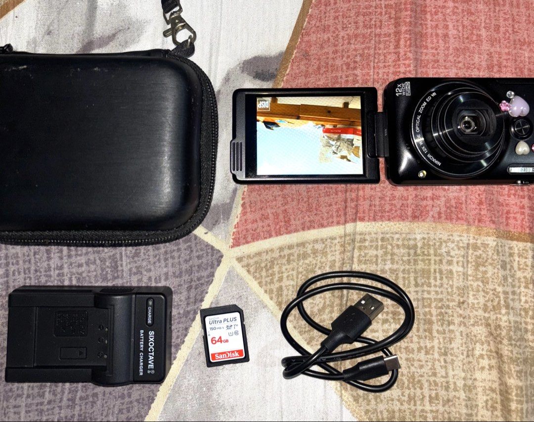 Nikon Coolpix Digital Camera Bundle with Charger and Case (Category: Cameras) located in Davao. Submitted by jay_rave26 (Listing ID 1470033853, Image 1). Description: - Model: Nikon Coolpix s6900 black (rare) compact digital camera (Black with cute stickers) - sample shots: last 2 slides - japanese language only but over all good - Lens: 12x optical zoom Nikkor lens - Condition: Fully working with clear test shot screen - Included Accessories: Si