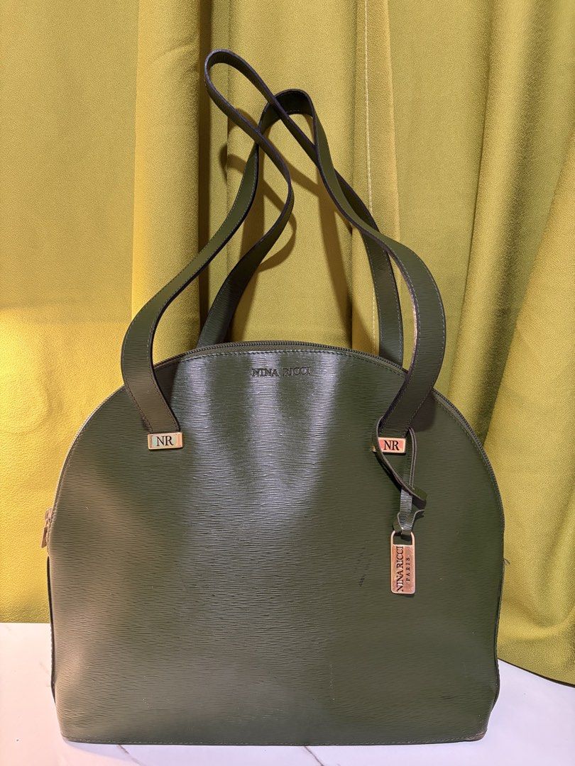 Nina Ricci Paris Shoulder Bag (Category: Shoulder Bags) located in Borongan. Submitted by charmspreloveddd (Listing ID 1470022802, Image 1). Description: - Brand: Nina Ricci Paris - Material: Premium green textured leather - Style: Dome-shaped tote with dual shoulder straps - Closure: Secure zip-top closure - Interior: Lined with a zippered pocket and gold-tone 'Made in France' logo plaque - Hardware: Distinctive metal 'NR' accents and matching f