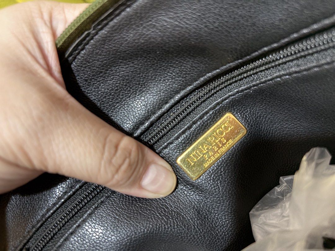 Nina Ricci Paris Shoulder Bag (Category: Shoulder Bags) located in Borongan. Submitted by charmspreloveddd (Listing ID 1470022802, Image 3). Description: - Brand: Nina Ricci Paris - Material: Premium green textured leather - Style: Dome-shaped tote with dual shoulder straps - Closure: Secure zip-top closure - Interior: Lined with a zippered pocket and gold-tone 'Made in France' logo plaque - Hardware: Distinctive metal 'NR' accents and matching f