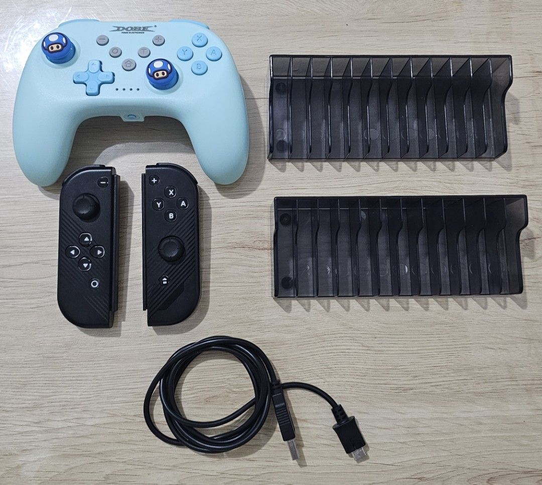 Nintendo Switch Controller Joy-Pads Game Holders Cable Bundle (Category: Controllers) located in Quezon City. Submitted by radio_3000 (Listing ID 1470066781, Image 1). Description: For Sale : NSW OLED ACCESSORIES Decluttering Switch Game Holder - 100 each Dobe Bluetooth controller (with thumb grips to replace damaged rubber) with charger - 400 Dobe Joypad (offline) - 400 800 take all Makati Area Ayala Triangle/Cash and Carry .