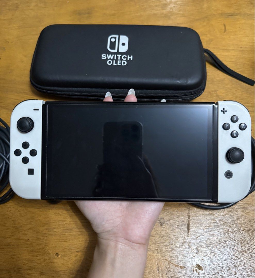 Nintendo Switch OLED Model White with SD Card and complete accessories (Category: Nintendo) located in Valenzuela. Submitted by wornandwandered (Listing ID 1470088302, Image 2). Description: - Nintendo Switch OLED Console (White) with cute case - Includes original power adapter, HDMI cable, joy-con controllers, straps, and grip - Comes with black carrying case - Fully tested and 100% working smoothly - with SD card 128gb - no games included - wit