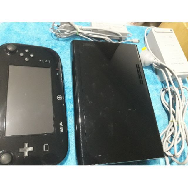 Nintendo Wii U Console and GamePad with Power Cords (Category: Nintendo) located in Makati City. Submitted by mariarm (Listing ID 1470064712, Image 1). Description: - Complete black Nintendo Wii U bundle with console and GamePad - Includes original power adapters and charging cables - Fully tested, powers on, and works properly - Normal surface scuffs and fingerprints from regular handling - Ready for your favorite classic Wii U games.
