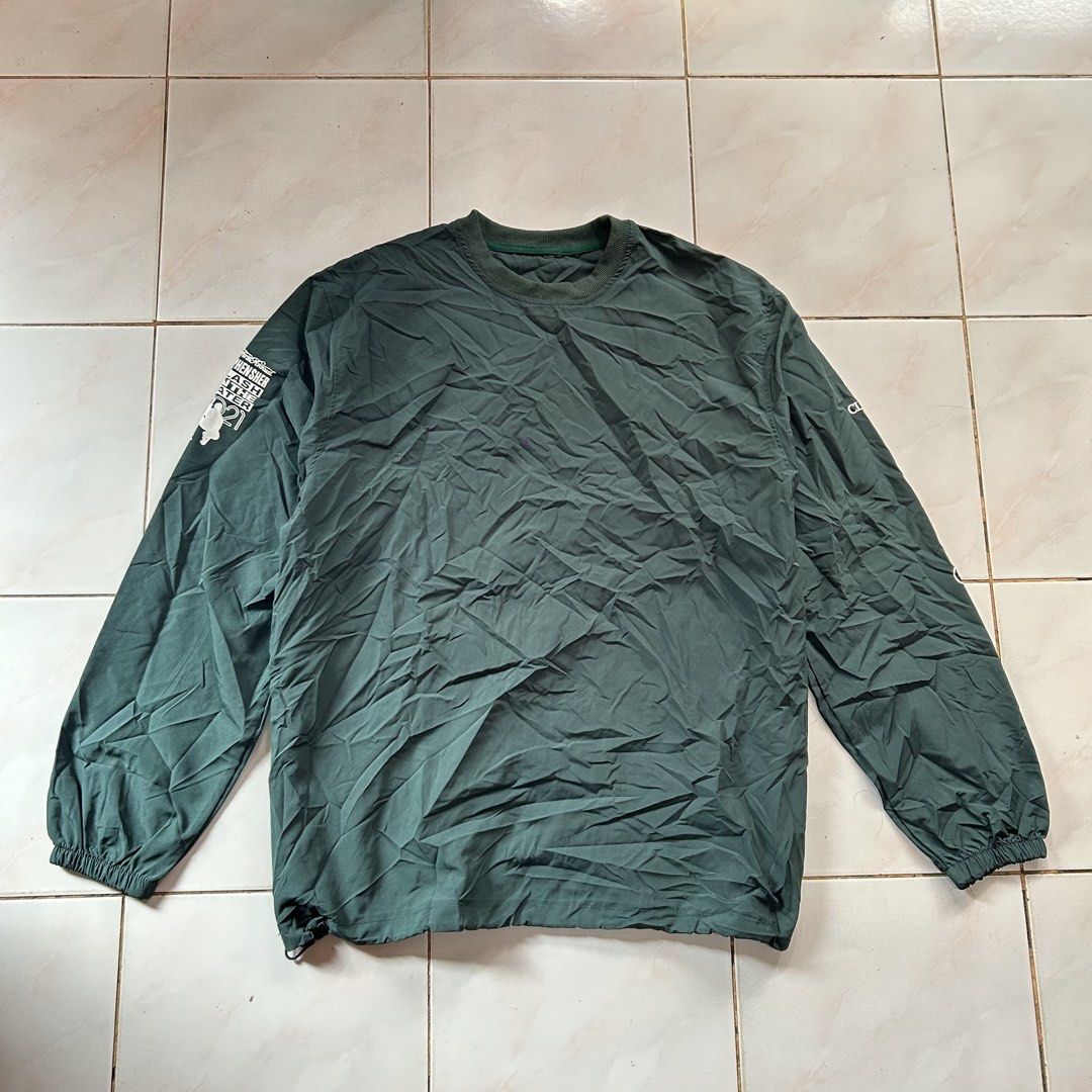 NOCTA Golf Dark Green Windbreaker 🥵 (Category: Coats, Jackets and Outerwear) located in Jinoba-an. Submitted by eegiboy (Listing ID 1470003395, Image 2). Description: - Dark green NOCTA golf windbreaker - Large NOCTA branding and golf graphic on the back - Stylish white text prints on sleeves - Crewneck collar with ribbed detailing - Elastic cuffs and adjustable drawstring hem - Lightweight material, perfect for layering over a tee Wts: Atcon lo