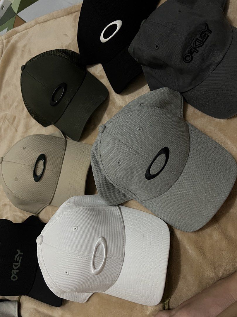 Oakley Baseball Cap Hat Collection Multiple Colors Available (Category: Caps & Hats) located in Binan City. Submitted by thetidyqueen (Listing ID 1470076692, Image 1). Description: - Brand: Oakley - Available Colors: White, Black, Grey, Dark Grey, Khaki, and Olive Green - Design: Iconic oval logo on the front; select styles feature script logo embroidery - Fit: Structured panels with a curved brim and adjustable back strap - Condition: Brand new 