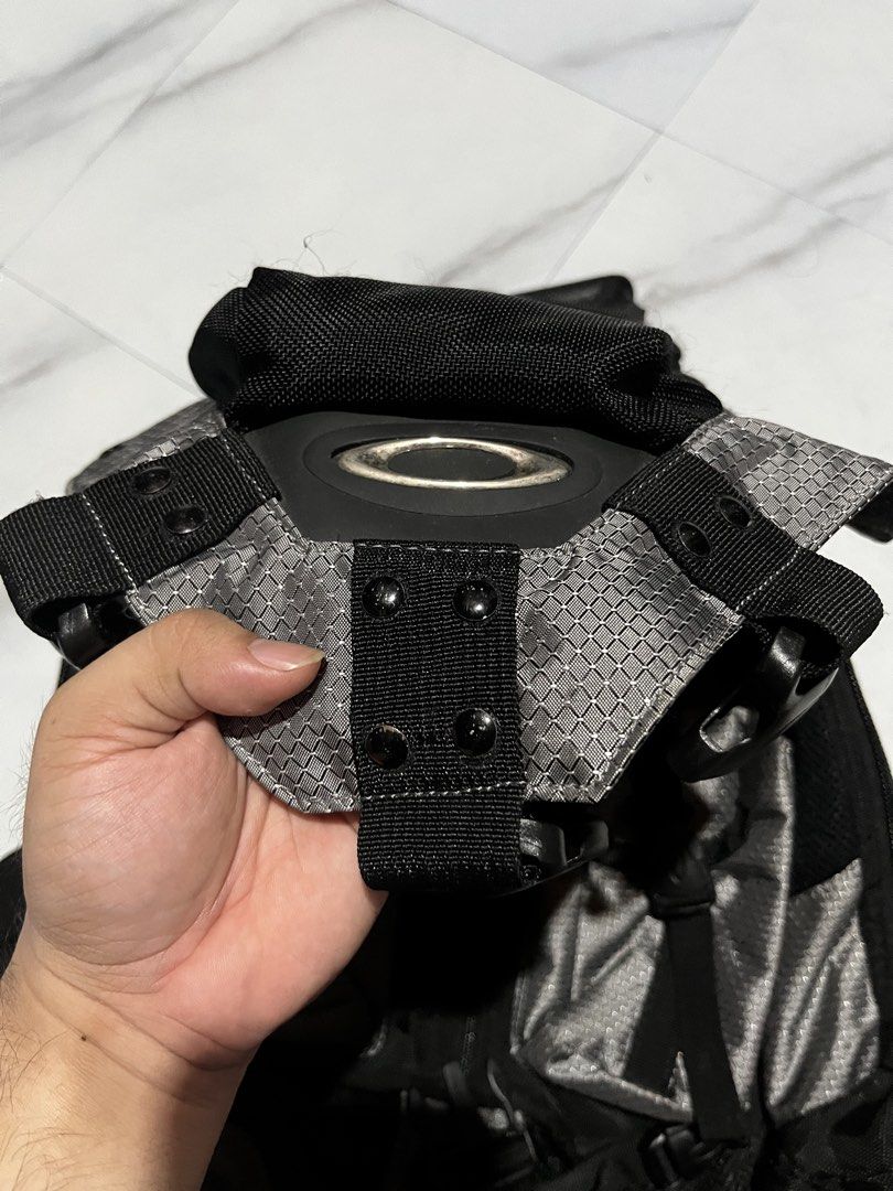 Oakley Technical Grey Black Backpack (Category: Backpacks) located in Cavite. Submitted by christianzuuu (Listing ID 1469959461, Image 2). Description: - Brand: Oakley - Legit/ Off lang - Color: Grey and Black - Style: Outdoor gear / Urban utility - Design: Structured geometric pattern panels with heavy-duty buckles - Comfort: Padded mesh back panel for support and breathable wear - Straps: Adjustable padded shoulder straps with snap button adjus