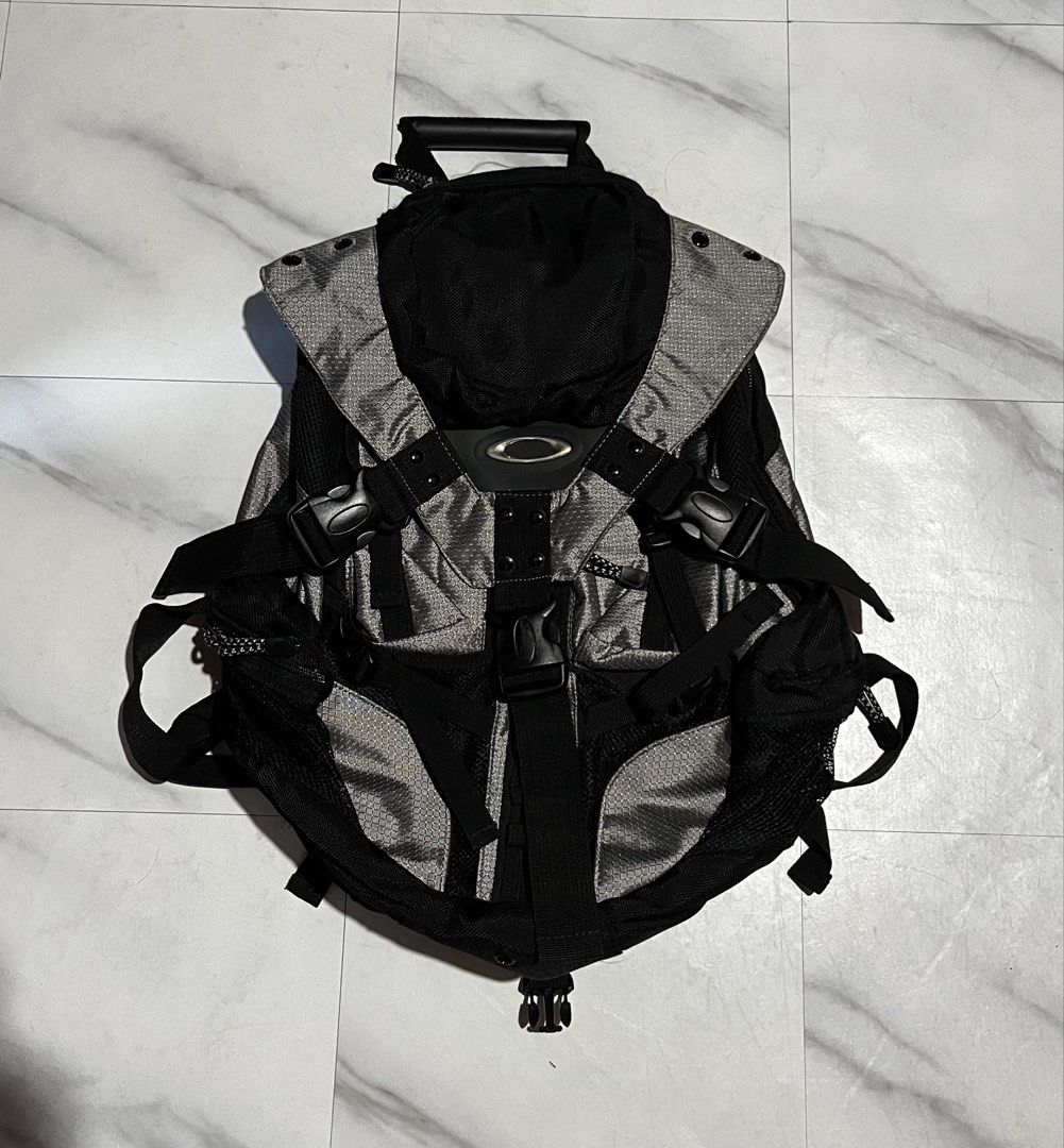 Oakley Technical Grey Black Backpack (Category: Backpacks) located in Cavite. Submitted by christianzuuu (Listing ID 1469959461, Image 1). Description: - Brand: Oakley - Legit/ Off lang - Color: Grey and Black - Style: Outdoor gear / Urban utility - Design: Structured geometric pattern panels with heavy-duty buckles - Comfort: Padded mesh back panel for support and breathable wear - Straps: Adjustable padded shoulder straps with snap button adjus