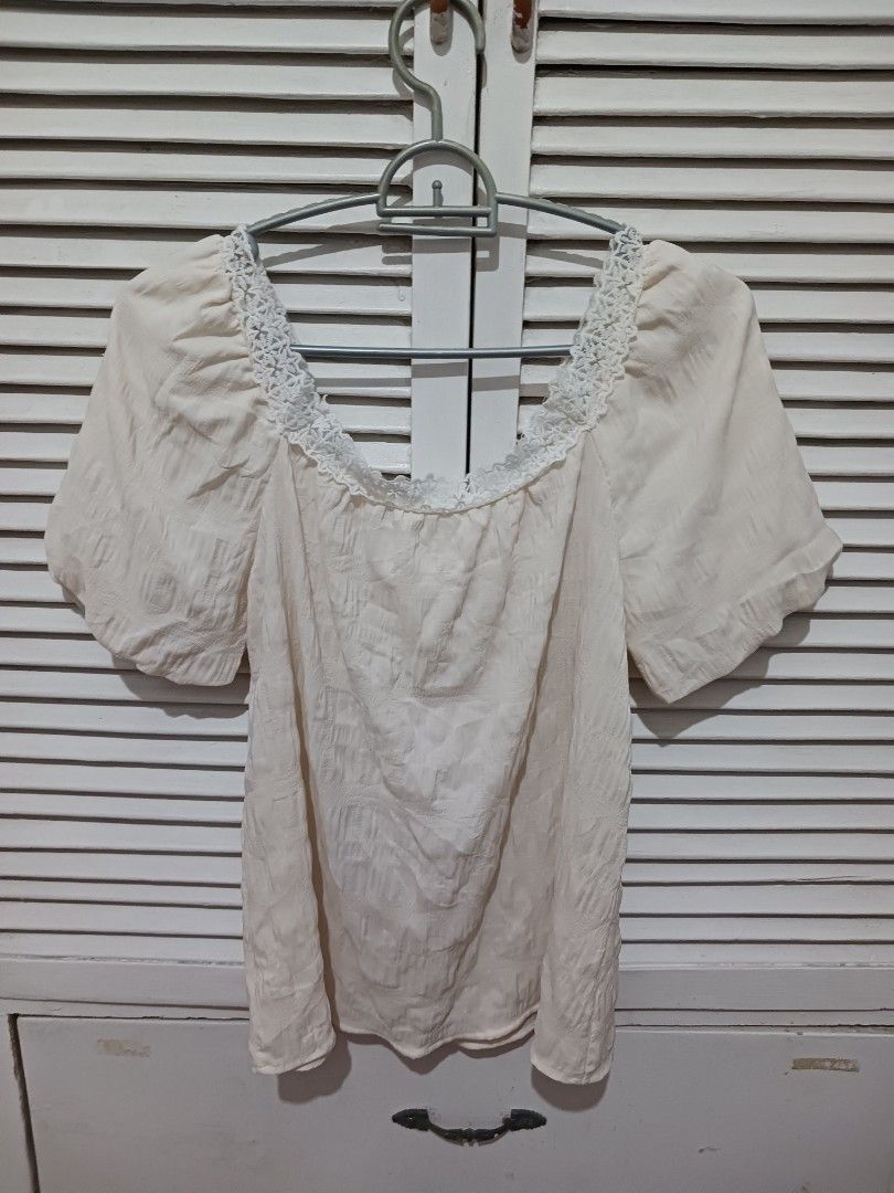 Off-shoulder cream blouse with lace trim (Category: Blouses) located in Quezon City. Submitted by rdonelle (Listing ID 1470081756, Image 2). Description: - Cream off-shoulder top with textured fabric - Short puff sleeves and front tie closure - Features delicate crochet lace trim - Ideal for warm weather or casual outings - Easy to pair with high-waisted jeans or skirts - Condition: Clean and ready to wear.