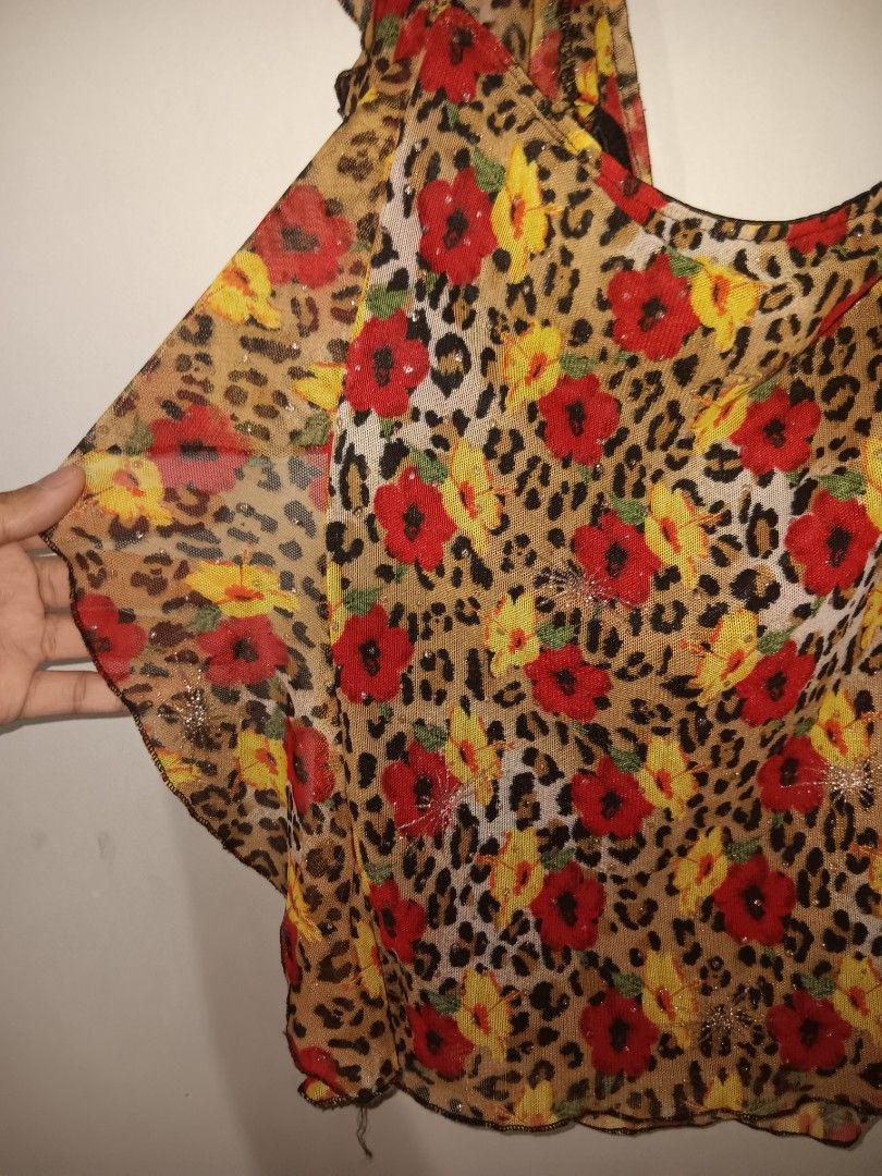 Off-Shoulder Leopard Print Floral Sheer Ruffle Blouse (Category: Blouses) located in Caloocan City. Submitted by gelo.is_selling (Listing ID 1470125596, Image 2). Description: - Material: Lightweight mesh with a bit of stretch - Design: Sheer fabric with cheetah print and mixed red and yellow flowers - Details: Ruffles around the collar and sleeves - Style: Fun statement piece, perfect for going out Measurement for reference: Chest: 33cm Waist: 3