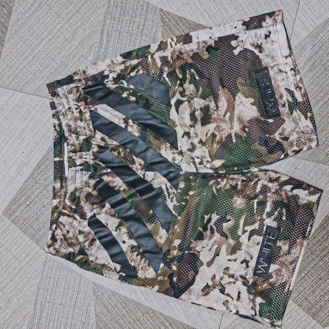 Off-White Camo Mesh Shorts (Category: Shorts) located in Manila. Submitted by charleshustla (Listing ID 1470110166, Image 1). Description: - Brand: Off-White - Design: Camo mesh shorts with signature black diagonal side stripes and white logo text near the hem - Material: Lightweight and breathable mesh fabric throughout - Fit: Comfortable elastic waistband with a black adjustable drawstring - Ideal for streetwear and casual summer fits.