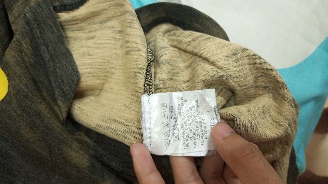 Off-White Camouflage Yellow Diagonal Print T-shirt (Category: Tshirts & Polo Shirts ) located in Manila. Submitted by rizu09 (Listing ID 1470040486, Image 3). Description: - Brand: Off-White - Item: Camo Tee - Size: Large (L) - Color/Wash: Dark grey and green camouflage - Details: Distressed collar and hems, big yellow box logo on upper back, diagonal stripes on lower back, small yellow text blocks near front hem - Material: Premium wool, polyest