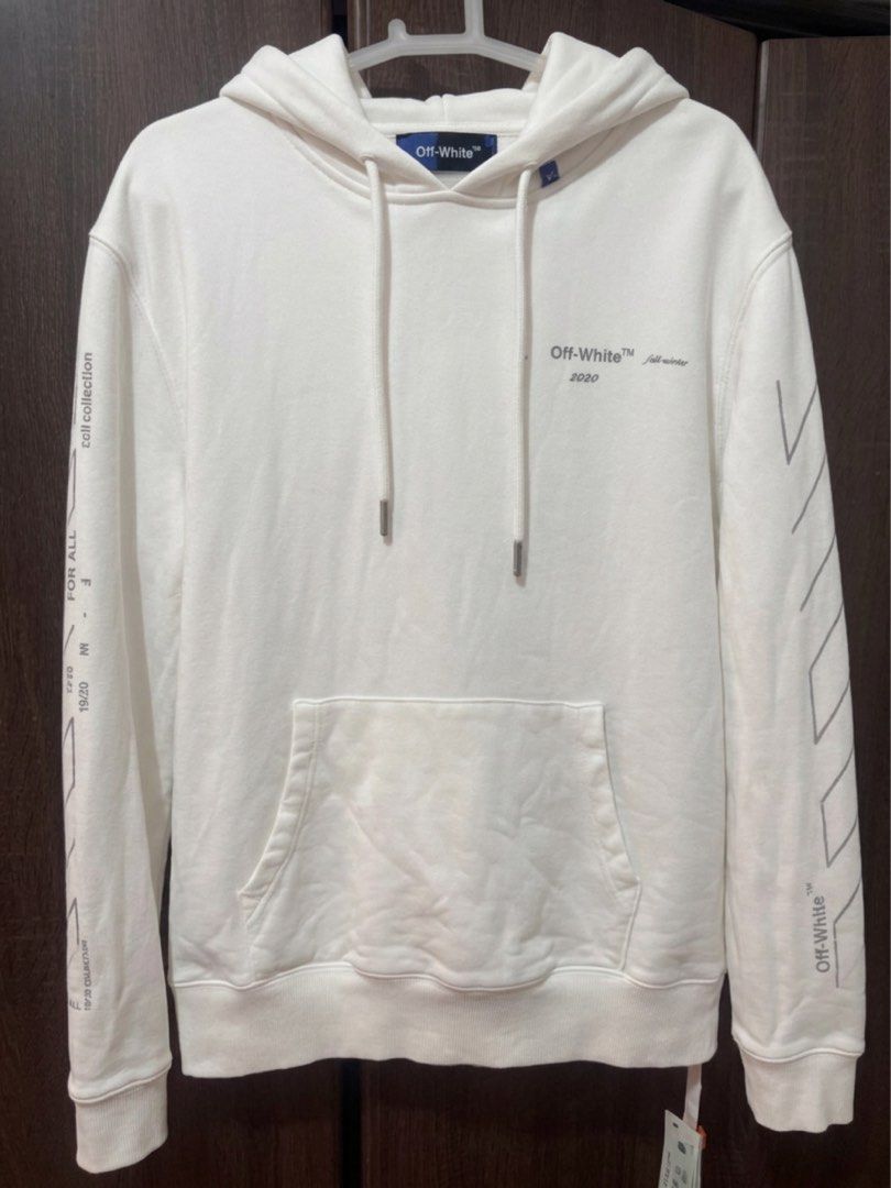 Off-White Fall Winter White Hoodie (Category: Hoodies) located in Manila. Submitted by jeromepsg12 (Listing ID 1470055683, Image 2). Description: - Brand: Off-White (Fall/Winter 2020 Collection) - Color: Clean White - Design: Iconic diagonal sleeve stripes, back arrow graphic, and chest branding text - Features: Drawstring hood, front pouch pocket, ribbed hem and cuffs - Fit: Relaxed fit, long sleeves - Style: Premium streetwear, ideal for cooler