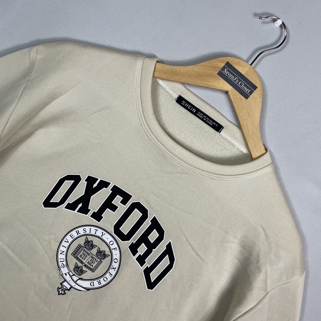 Off-White OXFORD Sweatshirt Unisex (Category: Coats, Jackets and Outerwear) located in Norzagaray. Submitted by sevenjscloset (Listing ID 1470017615, Image 2). Description: - Brand/Style: Off-White Oxford sweatshirt in neutral off-white cream - Size: Tagged XS, but relaxed fit fits like a Medium to Large - Measurements: 27 inches length, 21 inches width - Details: Collegiate chest print, classic crewneck style, ribbed cuffs and hem - Condition/Us