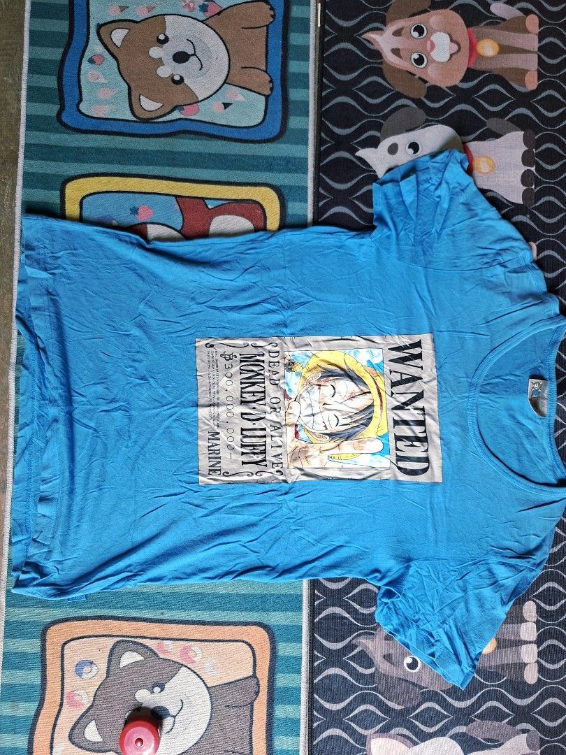 One Piece Monkey D. Luffy Wanted Poster T-Shirt (Category: Tshirts & Polo Shirts ) located in San Francisco. Submitted by manu2025 (Listing ID 1470137435, Image 1). Description: - Design: Eye-catching Monkey D. Luffy wanted poster graphic on the front - Color: Vibrant bright blue - Material: Soft, breathable 100% cotton - Fit: Standard casual fit with classic crew neck - Authenticity: Official One Piece tag inside the collar - Measurements: ~18.5
