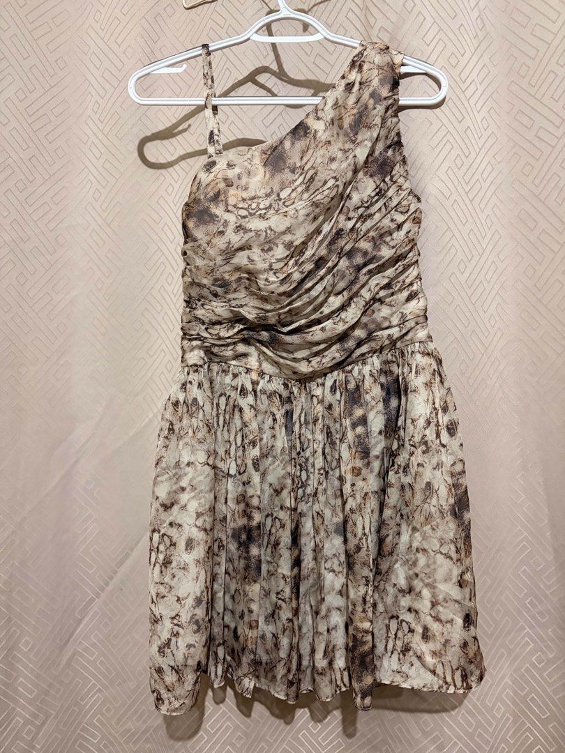 One-shoulder ruched printed mini dress (Category: Dresses) located in Manila. Submitted by janellecas75114 (Listing ID 1470077734, Image 1). Description: - Design: Stylish abstract pattern in shades of brown and beige - Style: Trendy one-shoulder with an asymmetrical neckline and thin strap - Bodice: Flattering ruched design with a textured wrap effect - Skirt: Flowy and flared, hits above the knee - Fit & Comfort: Side zipper closure and fully l