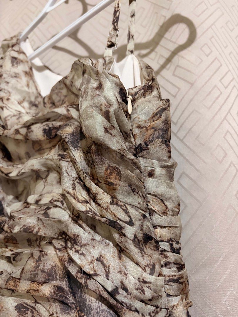 One-shoulder ruched printed mini dress (Category: Dresses) located in Manila. Submitted by janellecas75114 (Listing ID 1470077734, Image 2). Description: - Design: Stylish abstract pattern in shades of brown and beige - Style: Trendy one-shoulder with an asymmetrical neckline and thin strap - Bodice: Flattering ruched design with a textured wrap effect - Skirt: Flowy and flared, hits above the knee - Fit & Comfort: Side zipper closure and fully l