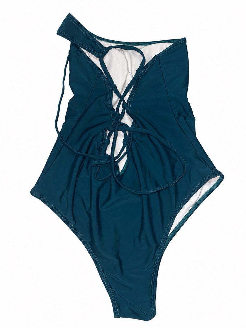 One-shoulder teal swimsuit with lace-up back (Category: Bikinis & Swimsuits) located in Marikina City. Submitted by ziaziaaa (Listing ID 1469956123, Image 2). Description: - Color: Deep teal/green-blue - Style: One-piece swimsuit with single shoulder strap - Details: Striking lace-up back with adjustable straps - Fit: High-cut leg opening, fully lined - Condition: USED ONCE.