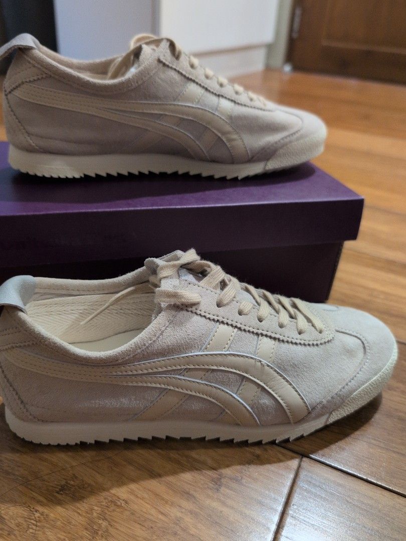 Onitsuka Tiger Mexico 66 Deluxe Nippon made (Category: Sneakers) located in Manila. Submitted by csisters3 (Listing ID 1469965610, Image 2). Description: - Brand: Onitsuka Tiger - Color: Beige cream - Material: Premium suede upper with ridged rubber sole - Style: Classic low-top casual sneakers with signature side stripes - Features: Cushioned insoles with red logo branding - Inclusions: Original purple box and matching laces - Condition: newly b
