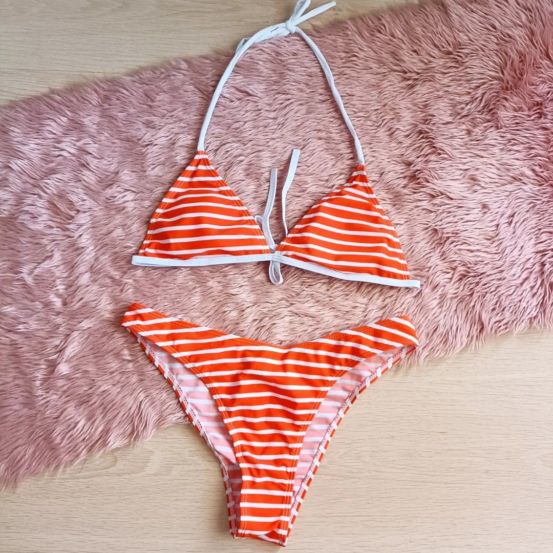 Orange and White Striped Bikini Set (Category: Bikinis & Swimsuits) located in Bacoor. Submitted by Miss_Chuch0521 (Listing ID 1470053087, Image 1). Description: - Style: Two-piece bikini with orange and white stripes - Top: Triangle halter with adjustable neck and back ties - Bottoms: Matching low-rise design - Perfect for: Beach trips, pool parties, and vacations.