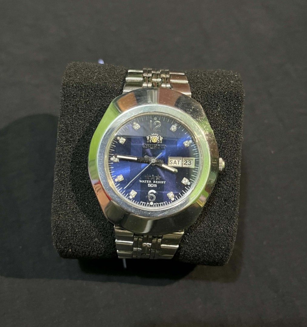 Orient 3 Star Blue Dial Automatic Watch (Category: Men's Watches) located in Cebu City. Submitted by jbok_watches. (Listing ID 1470101454, Image 1). Description: - Brand/Model: Vintage Orient 3 Star Automatic Watch - Dial: Striking blue patterned dial with crystal hour markers and 12/6 digits - Case & Strap: Silver stainless steel case and matching bracelet with signed logo clasp - Features: Day and date window at the 3 o'clock position - Movemen