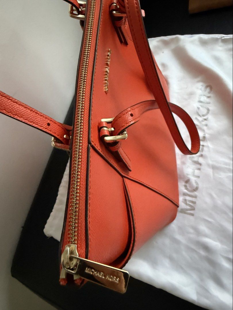 Authentic Michael Kors Charlotte – Retail (boutique) Version (Category: Luxury Bags & Wallets) located in Makati City. Submitted by fashio-anne (Listing ID 1470030249, Image 3). Description: Double leather straps with 10” drop Michael Kors Logo on Front 2 Slip pockets on the side Zipper top closure Interior MK logo lining 1 big pocket, 1 zipper pocket, and 2 slip pockets Measures 15-11” L- x 10” (H) x 4.5” (W) 9” Handle Drop Issue: stain on the p