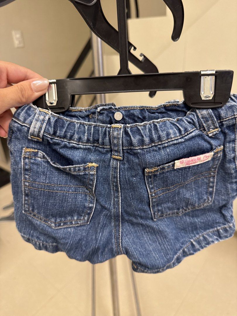 OshKosh B'gosh Denim Shorts Size M (Category: Babies & Kids Fashion) located in Manila. Submitted by __nix (Listing ID 1469998225, Image 2). Description: - Brand: OshKosh B'gosh - Color: Blue denim - Size: M (Tag) - Made in: Philippines - Waistband: Elastic at the back for a comfortable fit - Pockets: Front pockets with stylish contrast stitching + cute pink label on the back pocket - Closure: Metal button closure and zipper fly.