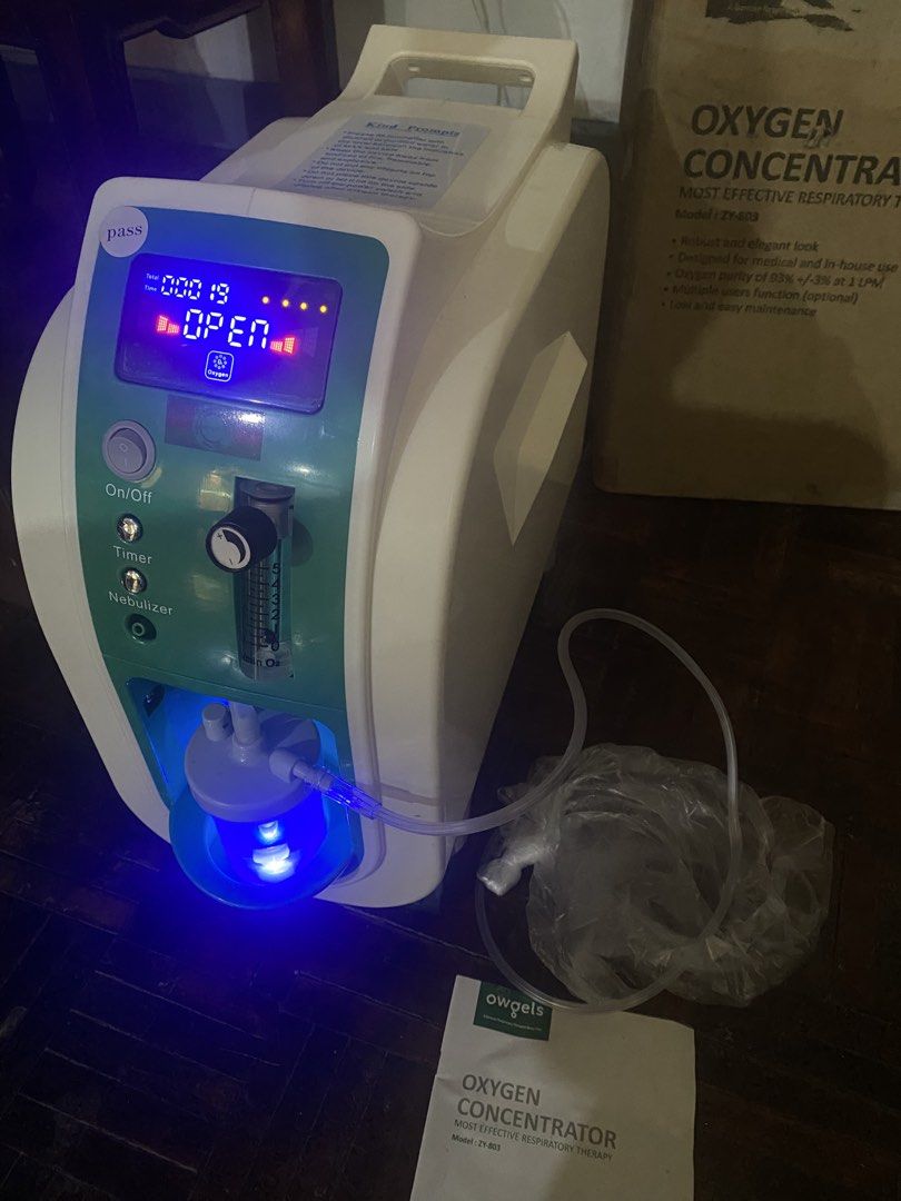Owgels Oxygen Concentrator Model ZY-803 (Category: Medical Supplies & Tools) located in Marikina City. Submitted by mykjet_fish (Listing ID 1470060595, Image 2). Description: Owgels Oxygen Concentrator (Model ZY-803) with Nebulizer function - Delivers 93% oxygen purity at 1 LPM - Ideal for home care and medical use - Powers on successfully with working blue display panel and controls - Complete set: includes humidifier bottle, nasal tubing, and u