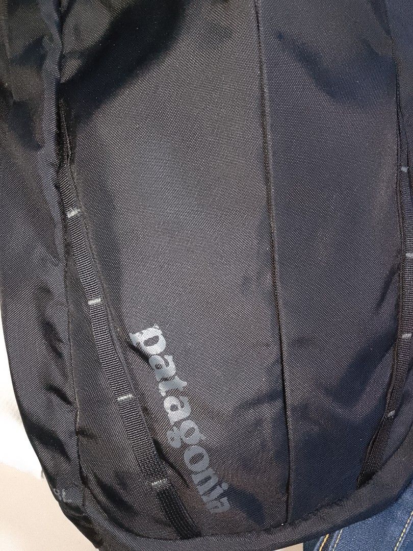 Patagonia Black Backpack (Category: Backpacks) located in Manila. Submitted by mjthrifted_second (Listing ID 1469984086, Image 2). Description: - Brand: Patagonia - Origin: Made in Vietnam - Material: 100% nylon shell with 100% polyester lining - Color: Solid black with grey interior - Compartments: Zippered front pocket and organizational mesh pockets inside - Comfort: Padded shoulder straps and back panel with logo tag - Condition: Clean inside