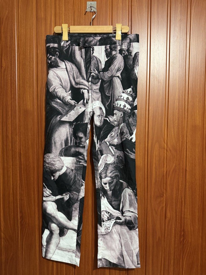 Pattric Boyle Renaissance Art Print Pants (Category: Jeans) located in Manila. Submitted by tlfph (Listing ID 1470109614, Image 2). Description: - Brand: Pattric Boyle - Design: All-over black and white Renaissance art print featuring historical and religious figures - Fit: Straight leg with a structured waistband and belt loops - Closure: Standard button closure - Details: Interior tag displaying the brand name repeatedly - Condition: Excellent 