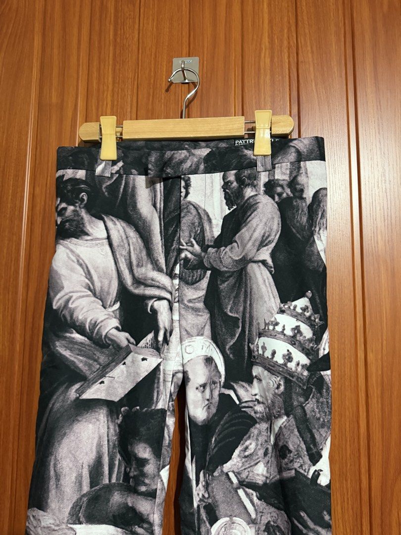 Pattric Boyle Renaissance Art Print Pants (Category: Jeans) located in Manila. Submitted by tlfph (Listing ID 1470109614, Image 3). Description: - Brand: Pattric Boyle - Design: All-over black and white Renaissance art print featuring historical and religious figures - Fit: Straight leg with a structured waistband and belt loops - Closure: Standard button closure - Details: Interior tag displaying the brand name repeatedly - Condition: Excellent 