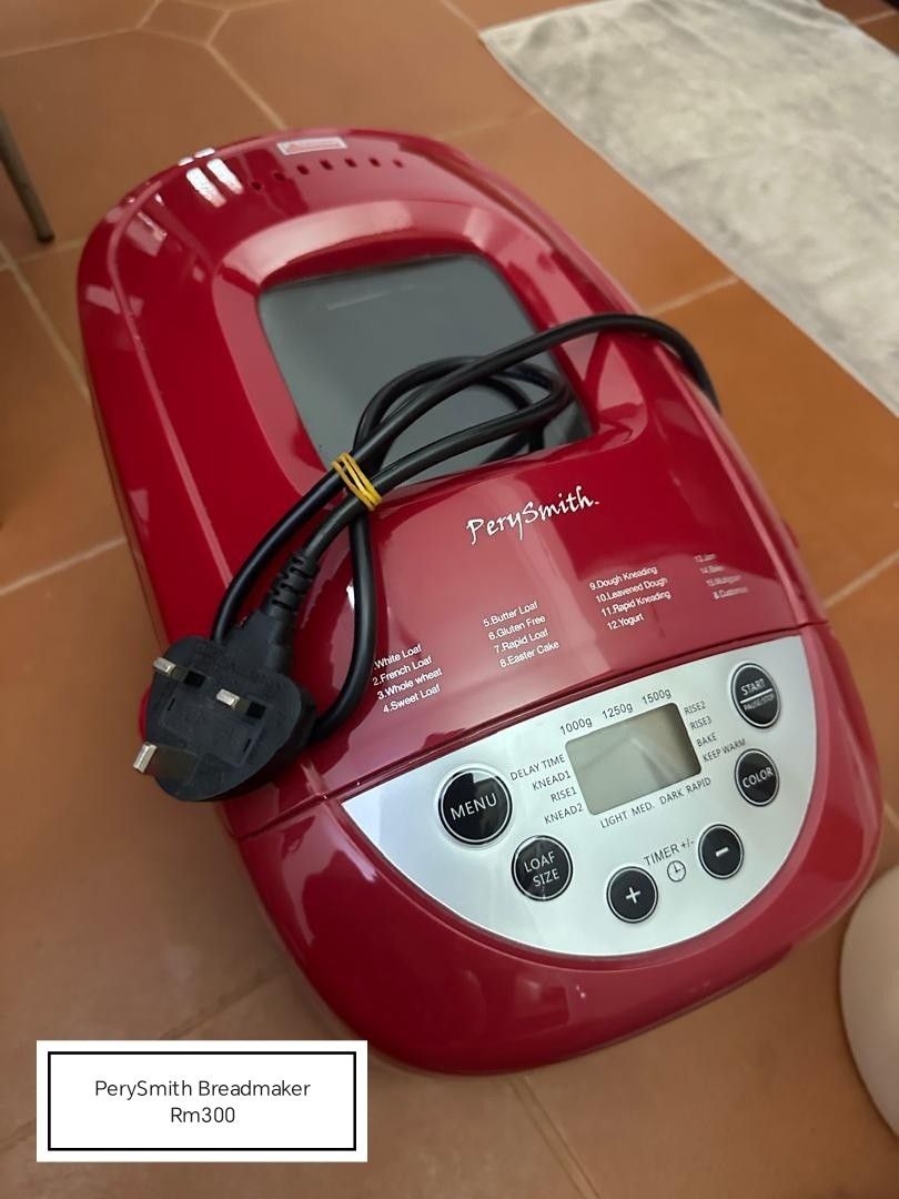 PerySmith Breadmaker Red (Category: Breadmakers) located in Kuantan. Submitted by denise.aq (Listing ID 1470118496, Image 1). Description: - Brand: PerySmith - Color: Striking Red - Programs: White loaf, French loaf, whole wheat, sweet loaf, gluten-free, dough kneading, and yogurt - Capacity: Adjustable loaf size from 1000g to 1500g - Features: Digital display panel, crust color control, and timer buttons - Condition: Clean exterior, ready for ba