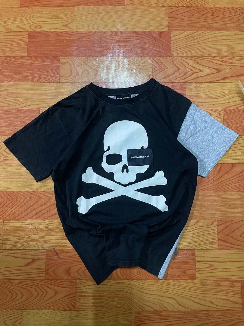Phenomenon x Mastermind Japan Skull T-Shirt (Category: Tshirts & Polo Shirts ) located in Ozamiz City. Submitted by tripft.vonde (Listing ID 1470048503, Image 1). Description: - Brand: Phenomenon x Mastermind Japan Collaboration - Size: L - Design: Large front skull and crossbones graphic with branded tag overlay - Back Details: Phenomenon and Mastermind Japan text with smaller skulls - Unique Feature: Contrasting grey right sleeve and matching r