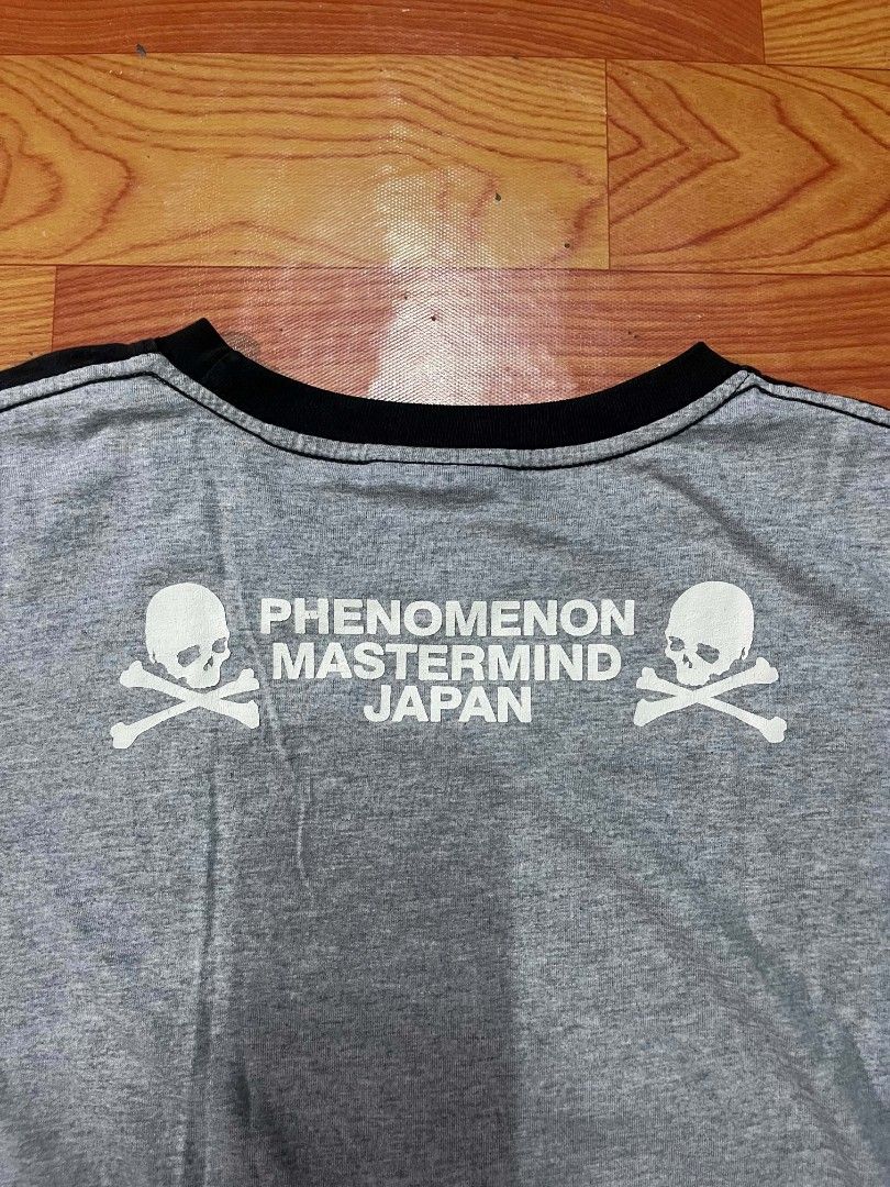 Phenomenon x Mastermind Japan Skull T-Shirt (Category: Tshirts & Polo Shirts ) located in Ozamiz City. Submitted by tripft.vonde (Listing ID 1470048503, Image 3). Description: - Brand: Phenomenon x Mastermind Japan Collaboration - Size: L - Design: Large front skull and crossbones graphic with branded tag overlay - Back Details: Phenomenon and Mastermind Japan text with smaller skulls - Unique Feature: Contrasting grey right sleeve and matching r