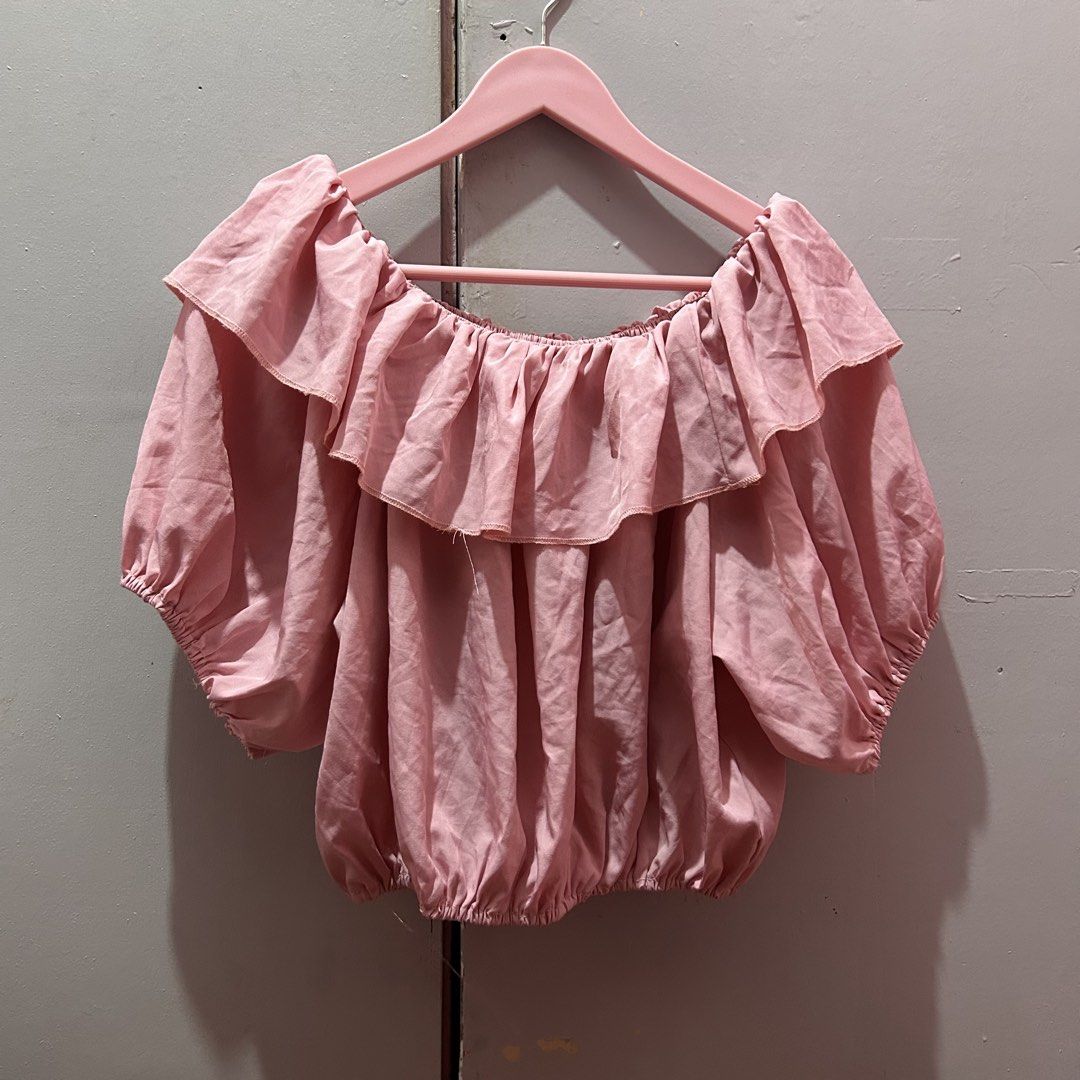 Pink Coquette Off-Shoulder Ruffle Top Blouse (Category: Blouses) located in Mandaluyong City. Submitted by strawbyeries (Listing ID 1470088636, Image 1). Description: - Color: Dusty pink - Design: Off-shoulder with a dramatic ruffled collar overlay - Sleeves: Balloon sleeves with elasticized cuffs - Fit: Elastic hem for a flattering blouson shape - Fabric: Light and flowy - Styling: Perfect to pair with your favorite jeans or skirt.