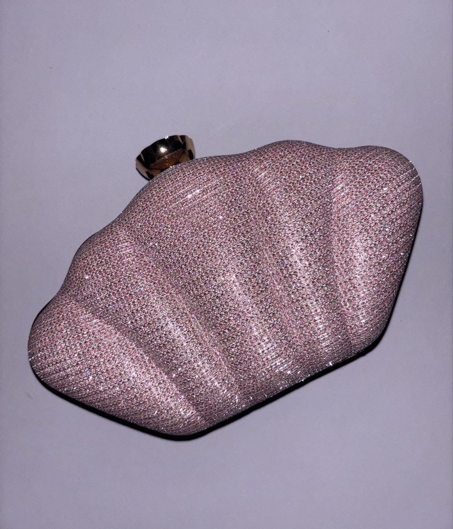 Pink glitter evening clutch with crystal clasp (Category: Clutches) located in Manila. Submitted by chn.ph (Listing ID 1469994651, Image 1). Description: 🐚 Color & Finish: Sparkly pink hard shell with all-over pleated texture 🧜‍♀️ Interior: Black fabric lining with enough space for your cards and lipstick 🪸Occasion: Ideal evening bag for weddings, parties, or dinner dates (Note: Used only once, but the metal chain strap is missing.).