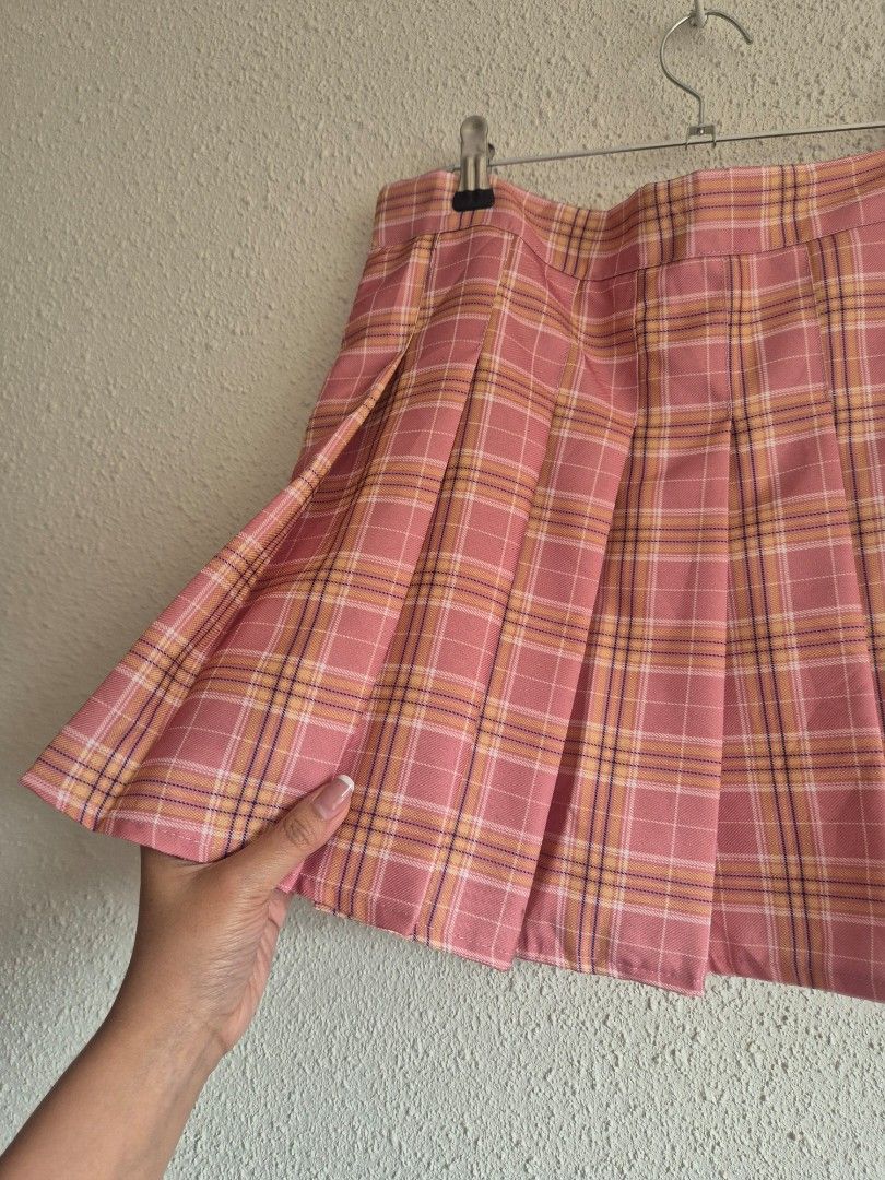 Pink Plaid Pleated Mini skirt (Category: Skirts) located in Manila. Submitted by belovedbyjess (Listing ID 1469972677, Image 2). Description: - Style: Preppy, casual, cute pleated skirt - Pattern & Color: Pink plaid - Fit: High waist with side zipper closure - Comfort: Soft material with built-in white inner lining W18 L 15.