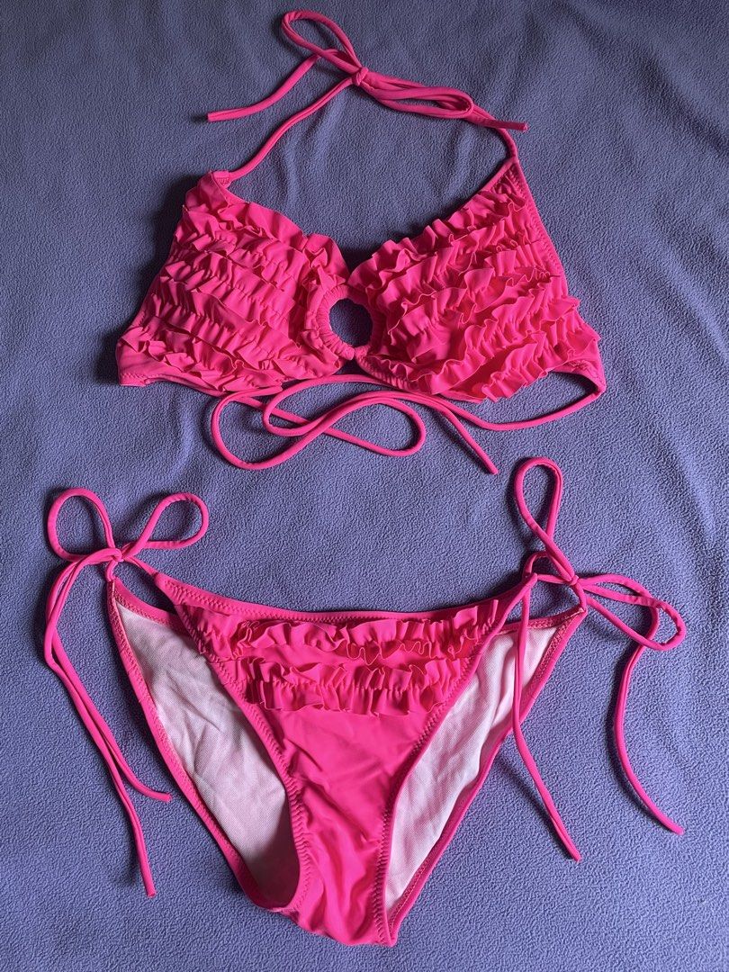 Pink Ruffle Halter Bikini Set (Category: Bikinis & Swimsuits) located in Antipolo. Submitted by chicgrc (Listing ID 1469967037, Image 1). Description: - Color: Bright pink - Style: Two-piece swimsuit with halter neck top and side-tie bottoms - Design: Ruffles, small center ring cut-out on the top, and layered ruffles on the back of the bottoms - Fit: Fully lined in white with adjustable ties on both top and bottom.