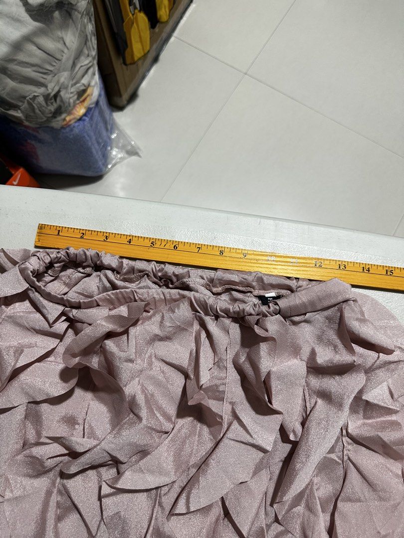Pink Ruffle Layered Mini Skirt Size L (Category: Skirts) located in Quezon City. Submitted by breakstuf50 (Listing ID 1470092900, Image 3). Description: - Color: Pink - Size: L (Tag attached) - Material: Silky shiny fabric - Fit: Elastic waistband (approx. 15 inches across laid flat) - Style: Mini skirt with layered ruffles - Condition: Great piece for casual outings or parties.