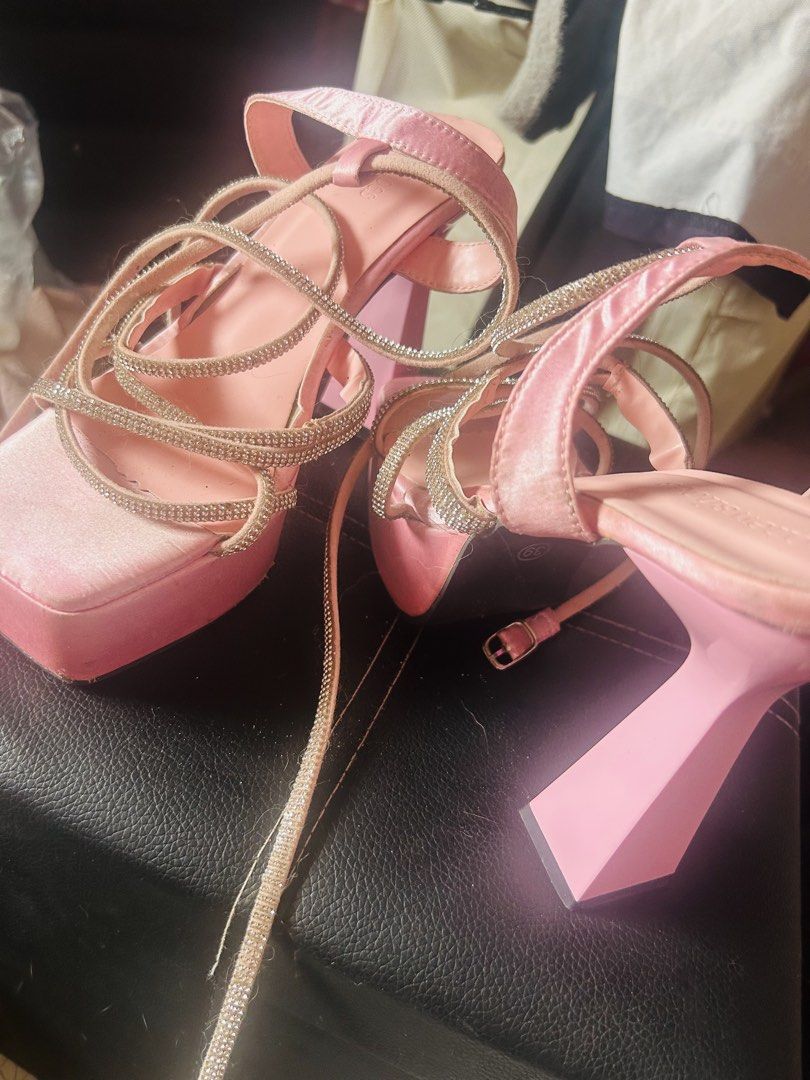 Pink Satin Platform Heels With Rhinestone Straps (Category: Heels) located in Pasig City. Submitted by karinauhh (Listing ID 1470027666, Image 3). Description: - Style: Pink satin platform heels with trendy flared block heels and square toe - Accents: Sparkly rhinestone straps wrapping the foot and ankle - Size: 39 (stamped on sole) - Condition: Pre-loved, worn a few times with visible scuffs on the toe area and insoles - Perfect for parties, nig