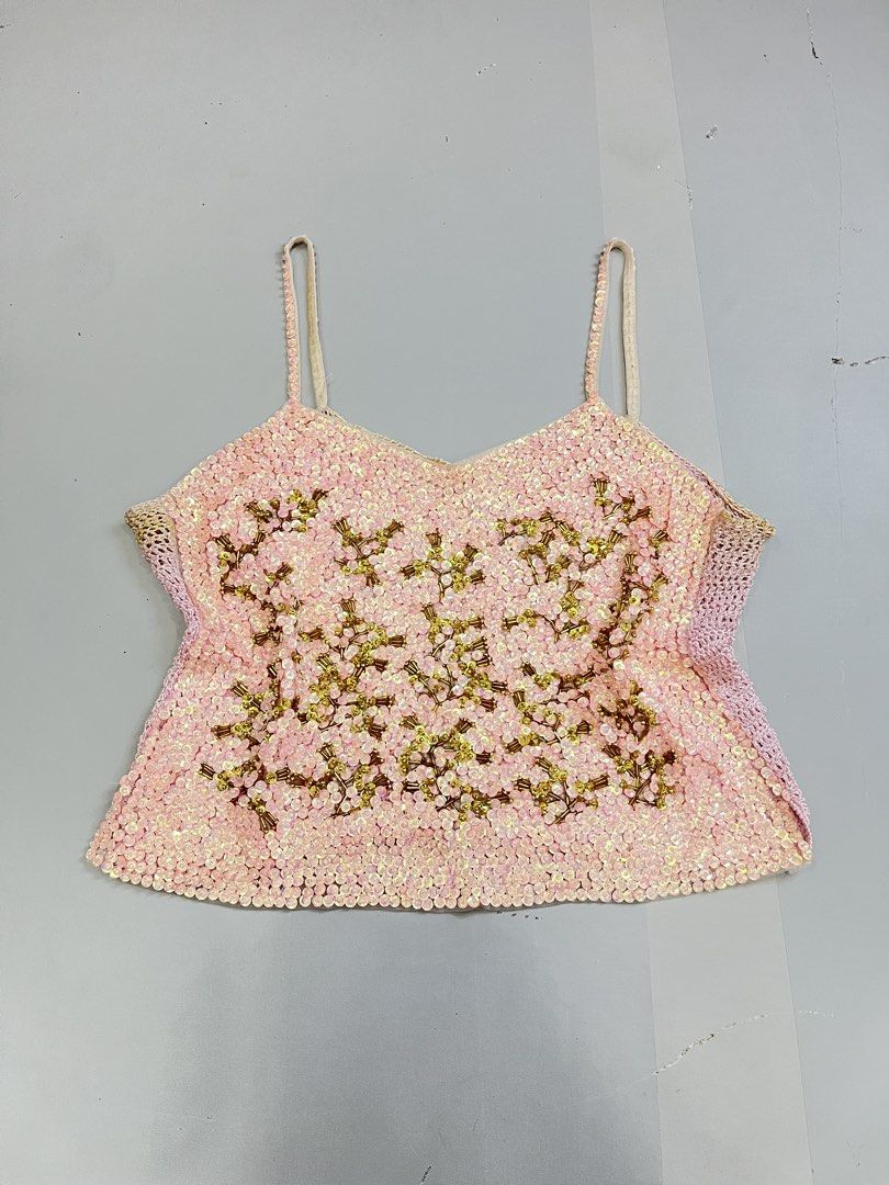 Pink Sequin Beaded Camisole Tank Top (Category: Sleeveless) located in Mabalacat. Submitted by aas_thriftfings (Listing ID 1470135074, Image 1). Description: - Color: Light pink with shimmering sequins and metallic gold bead embroidery - Design: Thin spaghetti straps, open knit mesh side panels, and straight hemline - Style: Eye-catching statement piece for nights out, parties, and special events - Versatility: Pairs easily with both casual and d