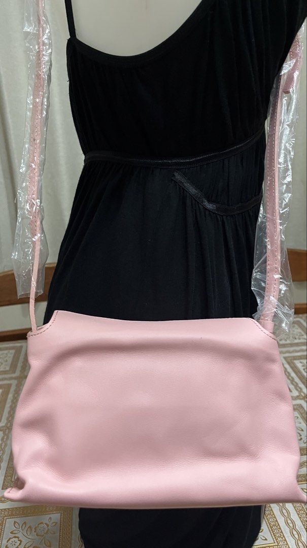 Pink sling bag (Category: Purses & Pouches) located in Bacoor. Submitted by ayit. (Listing ID 1470058361, Image 2). Description: Orig new - Brand: bucks & leather (Made-Seoul) - Color: Pink - Style: Sling bag / Crossbody - Material: Soft leather - Condition: Good pre-loved condition - Features: Adjustable strap, clean interior lining.