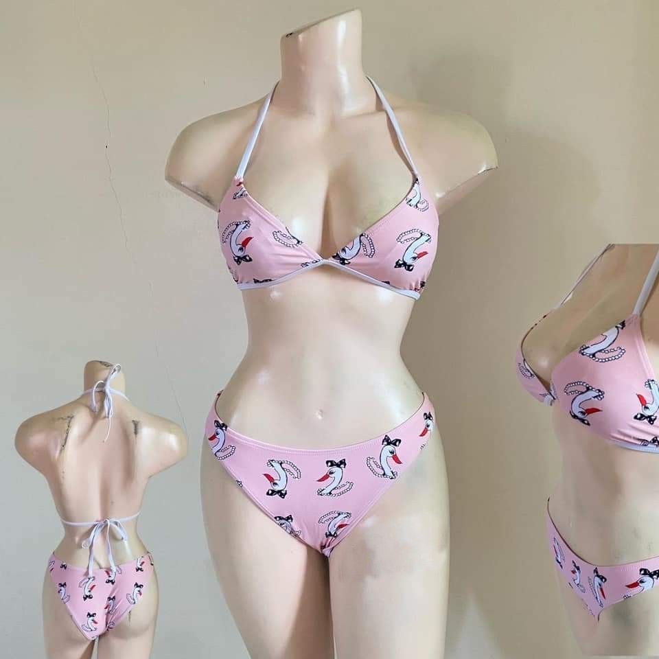 Pink Swan Print Halter Bikini Set (Category: Bikinis & Swimsuits) located in Bacoor. Submitted by Miss_Chuch0521 (Listing ID 1470053097, Image 2). Description: - Pink two-piece bikini with adorable swan and pearl necklace pattern - Triangle halter top with adjustable neck and back ties for a custom fit - Matching low-rise cheeky bottoms with chic white trim details - Ideal for pool parties, beach days, and summer getaways - DM for measurements or