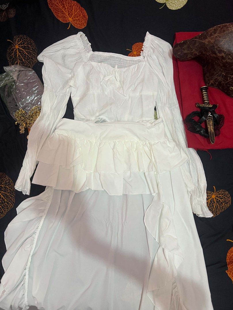 Pirate costume (woman) (Category: Dresses) located in Dasmarinas. Submitted by kziamar (Listing ID 1470054355, Image 3). Description: For sale❗️❗️❗️ Pirate costume for woman Perfect for Christmas party themed outfits Still negotiable Size: medium to large frame ✅✅Inclusion - White blouse - white skirt - red scarf - black binder/belt - gold waist accessory - necklace with skull - brown hat - thigh dagger (fake) ❌❌not included: boots.