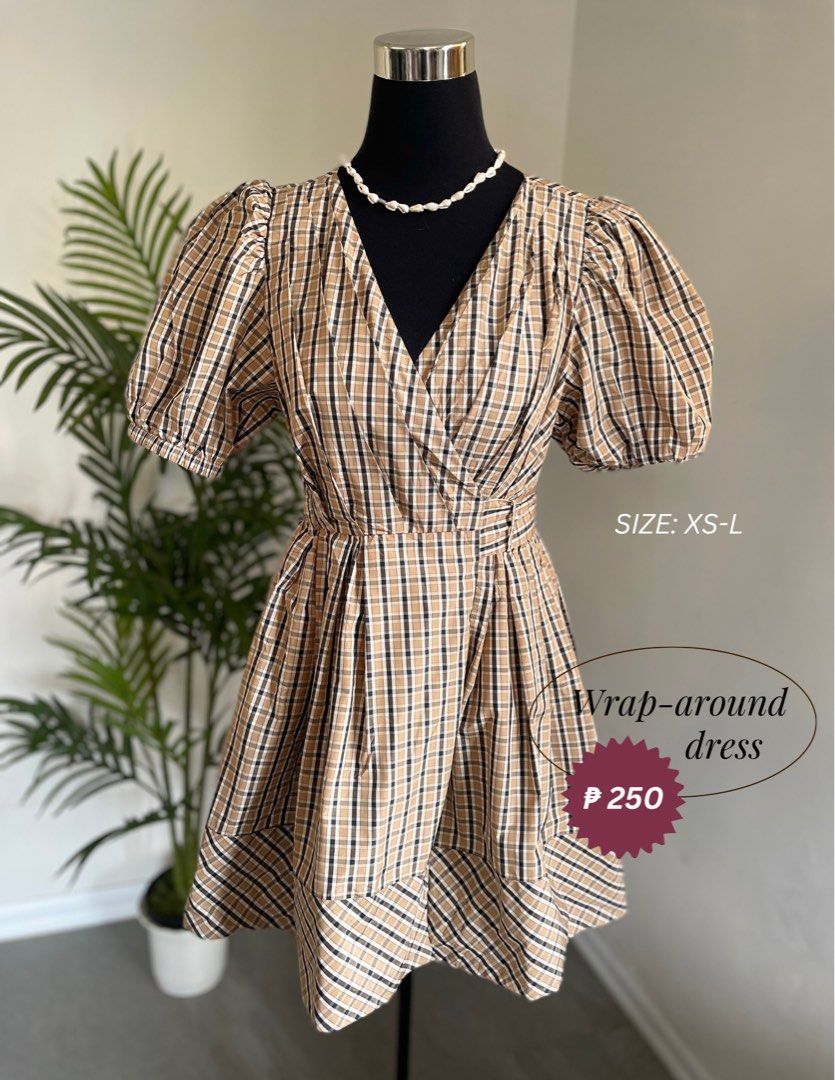Plaid Brown Puff Sleeve Wrap Dress (Category: Dresses) located in Pasig City. Submitted by kbolshoppe.kyla (Listing ID 1470129871, Image 1). Description: - Brown and black plaid wrap-around dress - Short puff sleeves with a voluminous shape - Flattering V-neck crossover style - Cute flared ruffled hemline - Structured volume fabric that holds its shape - Adjustable wrap design fits XS to Large - Ideal for casual daily outfits and out-of-town trip