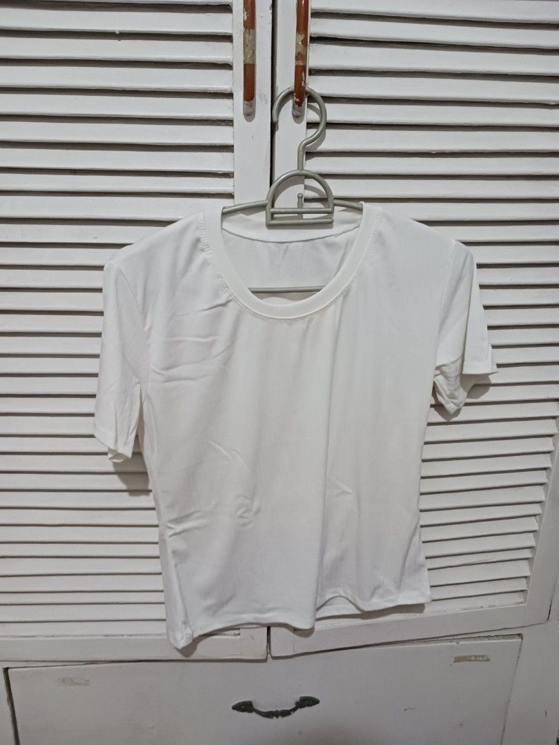 Plain White Short-Sleeve T-Shirt Basic Tee (Category: Shirts) located in Quezon City. Submitted by rdonelle (Listing ID 1470095476, Image 1). Description: - Color: Classic White - Fit: Regular fit, short sleeves - Neckline: Round neck / Crew neck - Fabric: Soft, comfortable material - Style: Solid color, versatile everyday staple - Condition: Brand new.