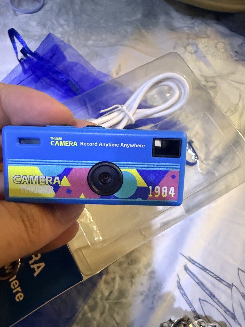 Playground Camera Thumb Key Chain blue (Category: Cameras) located in Quezon City. Submitted by cozykath (Listing ID 1469954035, Image 2). Description: Key Features & Specifications • Ultra-Compact Design: A pocket-sized, lightweight camera designed to be used as a keychain or backpack charm. • Rear Display: Features a small 0.96-inch color TFT LCD screen on the back for real-time image preview and menu navigation. • Video & Audio: Capable of rec