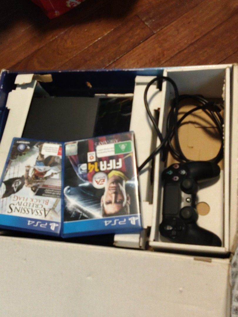 PlayStation 4 Console Bundle with Controller and Two Games (Category: PlayStation) located in Caloocan City. Submitted by cooldragon_0358ac (Listing ID 1469953040, Image 2). Description: PlayStation 4 console packed in original box. Includes one black DualShock 4 controller, power cable, and two games. FIFA 14 and Assassin's Creed IV Black Flag included. Everything stored properly in the cardboard insert. Great setup for gaming right away. (Price