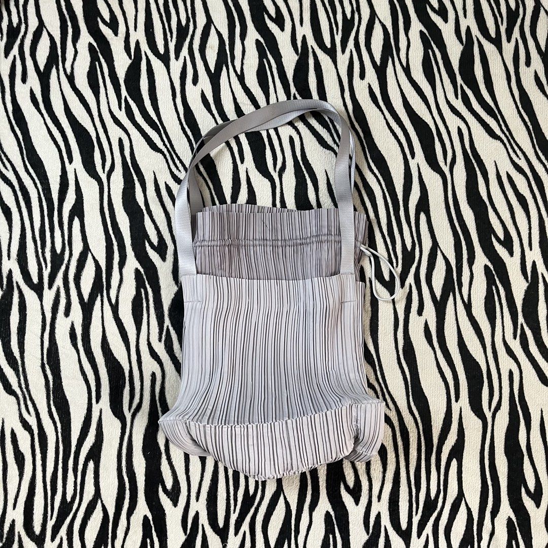 Pleats please drawstring bag (Category: Tote Bags) located in Manila. Submitted by royaldripmanila (Listing ID 1470047368, Image 1). Description: No issue W13 L15.